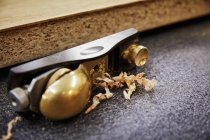 Wood plane with a brass handle — Stock Photo
