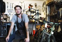 Portret of  man in bicycle shop. — Stock Photo