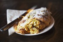 Fresh pastry an almond croissant — Stock Photo