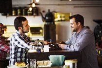 Barista and a client talking — Stock Photo