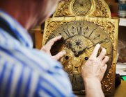 Clockmaker displaying his work. — Stock Photo