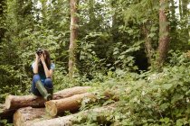 Young girl using binoculars. — Stock Photo
