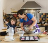 Woman and a child cooking at a kitchen — Stock Photo