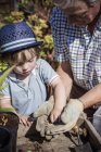 Man and a young child gardening — Stock Photo