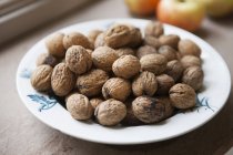 Bowl of walnuts on a kitchen table — Stock Photo