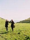 Two people on a coastal headland walking — Stock Photo