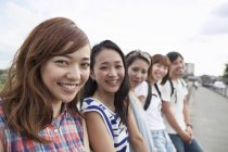 Group of japanese friends in the park — Stock Photo