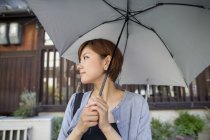 Woman holding an umbrella. — Stock Photo