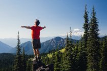 Male hiker standing with arms outstretched — Stock Photo