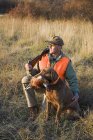 Bird hunter and his trained dog — Stock Photo