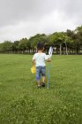 Japanese boy carrying a butterfly net. — Stock Photo