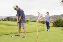 Japanese Couple on a golf course. — Stock Photo
