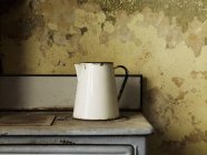 Vintage enamel jug of a traditional shape — Stock Photo