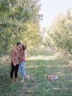 Couple kissing in Apple orchard — Stock Photo