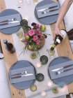 Table setting, a person pouring wine. — Stock Photo