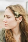 Woman with a flowers in her hair. — Stock Photo