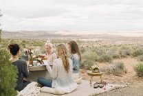Amis prendre un repas dans le désert — Photo de stock