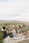 Amici che fanno un pasto nel deserto — Foto stock