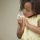 Girl holding a baby chick — Stock Photo