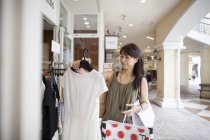 Woman looking at clothing — Stock Photo