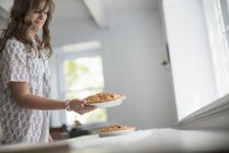 Woman carrying food to a table — Stock Photo
