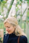 Blonde woman in a conservatory — Stock Photo