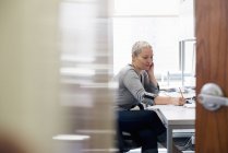 Woman working in an office alone — Stock Photo