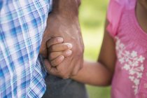 Young child holding father's hand. — Stock Photo