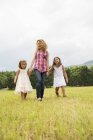Mother outdoors with her daughters. — Stock Photo