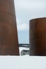 Tall rusting metal oil tanks — Stock Photo