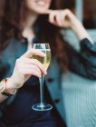 Woman holding a glass of white wine — Stock Photo