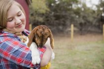 Girl cuddling goat. — Stock Photo