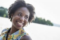 Woman laughing on a lake shore — Stock Photo