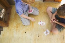 Brothers playing cards — Stock Photo