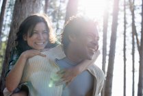 Couple hugging in shade of trees — Stock Photo