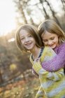 Smiling girls hugging each other — Stock Photo
