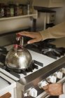 Stainless steel kettle on a stove. — Stock Photo