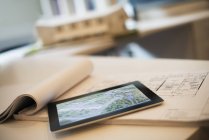 Architectural plans and a computer tablet. — Stock Photo