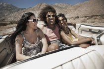 People in a pale blue convertible car — Stock Photo