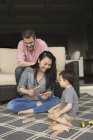Man and woman playing with young son — Stock Photo