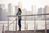 Woman standing on the waterfront — Stock Photo