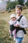 Woman carrying a baby — Stock Photo