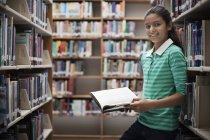Girl looking at books — Stock Photo