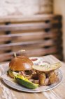 Hamburger in a bun with potato — Stock Photo