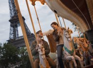 Couple on a carousel ride in Paris. — Stock Photo