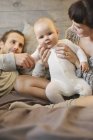 Mother, father and baby playing — Stock Photo