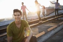 People on a rooftop in the city at dusk — Stock Photo