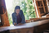 Woman working with reclaimed timber — Stock Photo