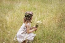 Young girl with flowers — Stock Photo