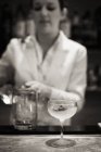 Woman mixing a cocktail — Stock Photo